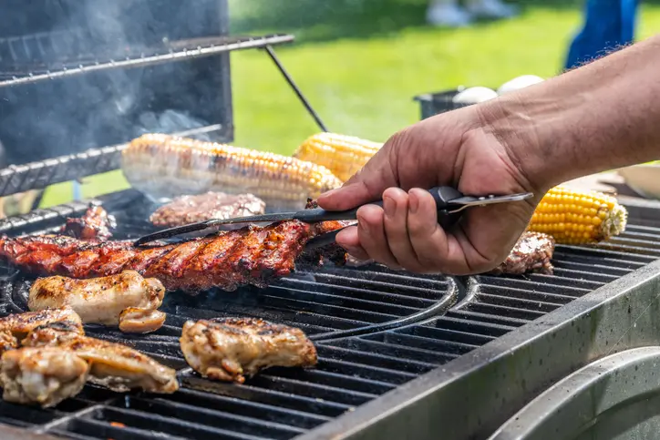 Foto de uma churrasqueira com carne e legumes.