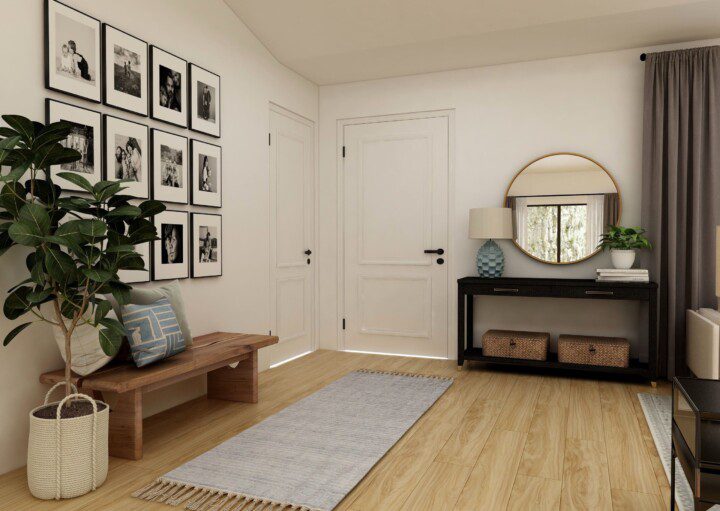 Hall de entrada decorado com quadros, espelho e tapete.