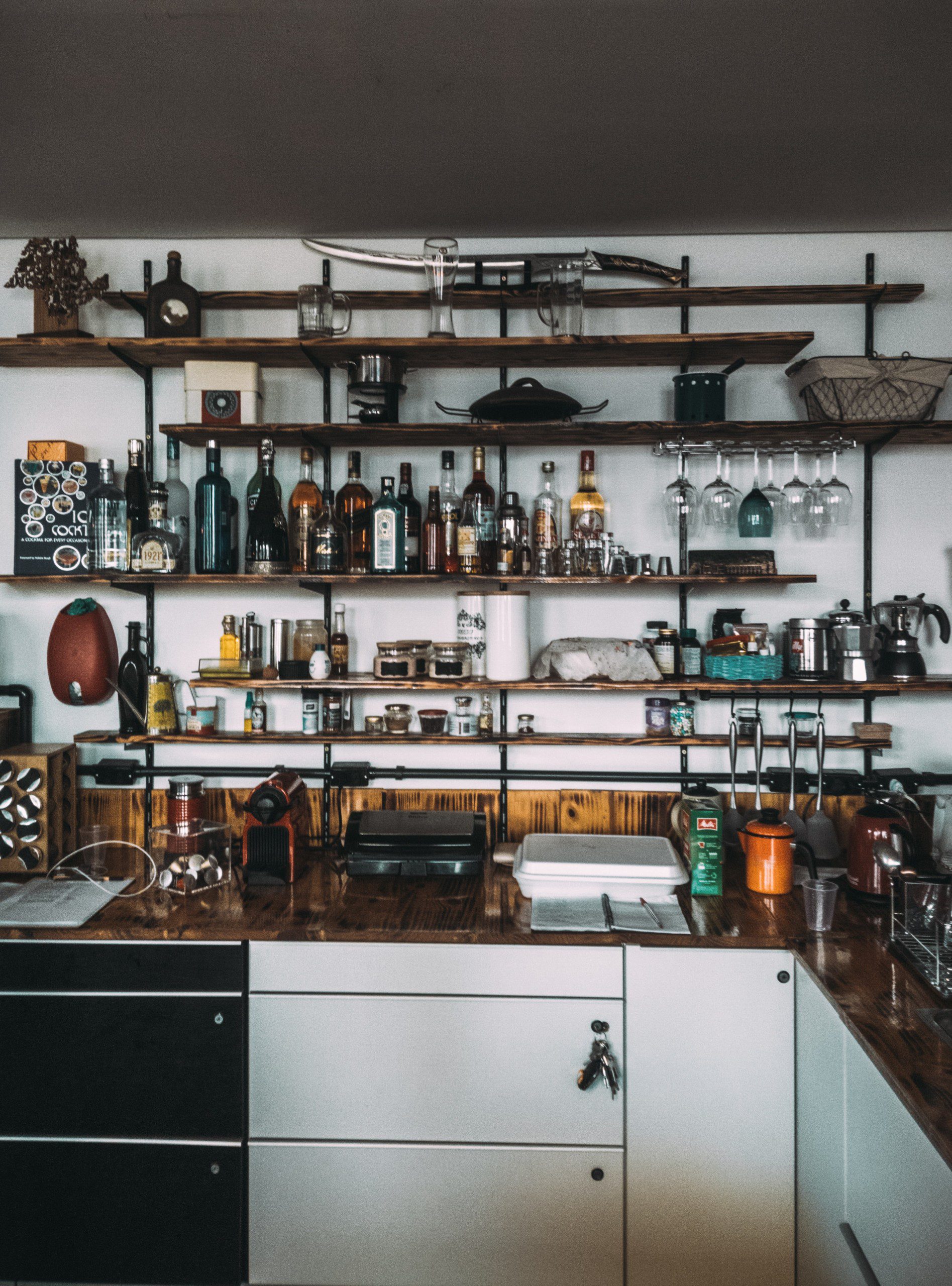 Estrutura de bar montado em uma cozinha em prateleiras de ferro. 