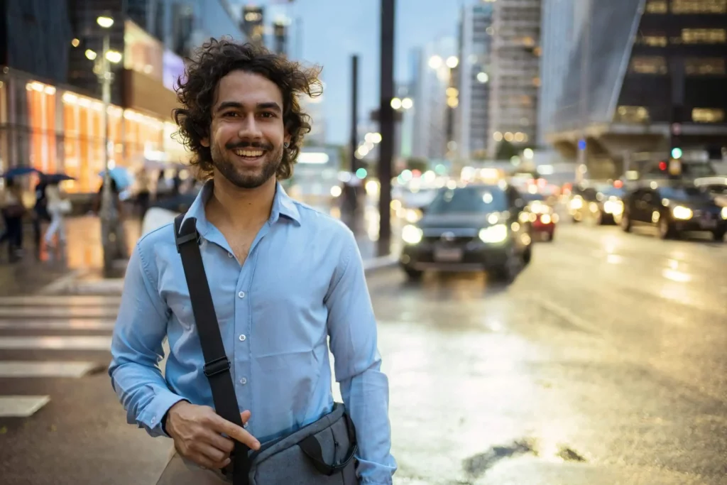 Imagem de um homem parado em frente a uma rua da Avenida Paulista, em São Paulo, no final do dia para ilustrar matéria sobre 20 cidades mais populosas do Brasil